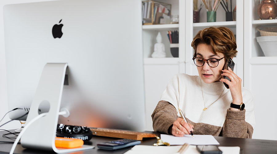 Business sales manager working from home making sales calls with her top sales tips to hand