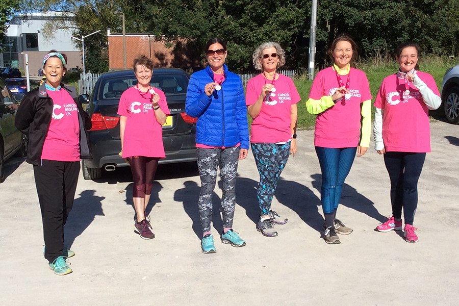 The Cancer Research runner after the event with the medals