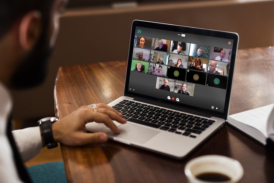 Business man enjoys NetworkIN referral marketing meeting on his Macbook computer